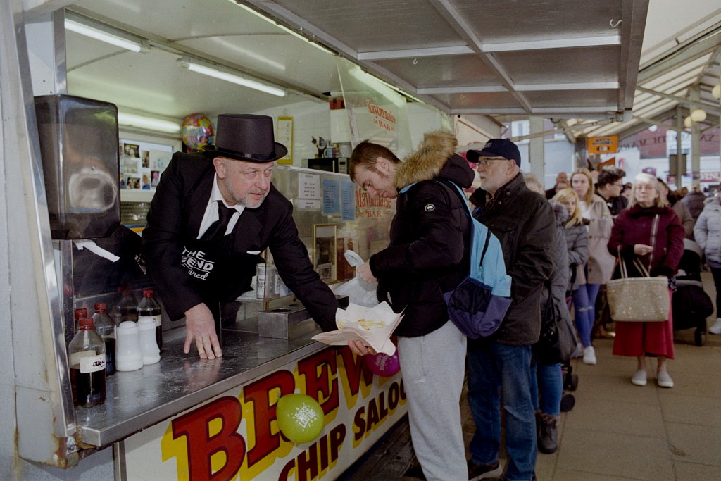 Robin Platten of Brewer's Chip Saloon serving customers in funeral attire on their last day of opening  at the old market place.  Brewer's has been trading since 1902 and will close when the market moves to a new area in the town.