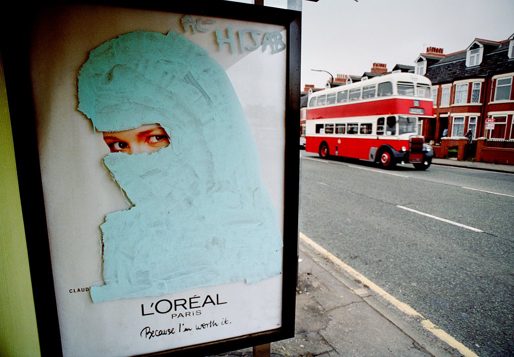 A niqab painted over a cosmetic advertisement featuring supermodel Claudia Schiffer in Manchester, UK